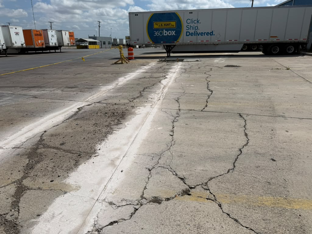 Deteriorated cracking across an exterior concrete pavement